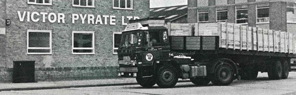 Camión de transporte frente a la fachada de Victor Pyrate Ltd en blanco y negro
